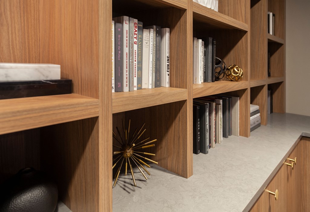 a book shelf with books on it and a gold starburst decoration on the floor