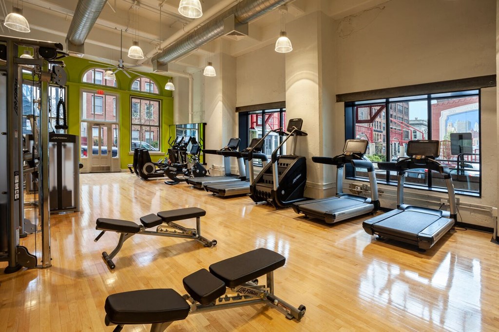 a gym with treadmills and other exercise equipment in a large room