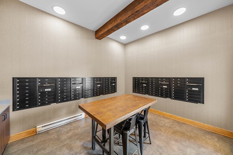 A conference room with a wooden table and black chairs.