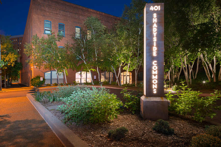 a city at night with a building and a sign