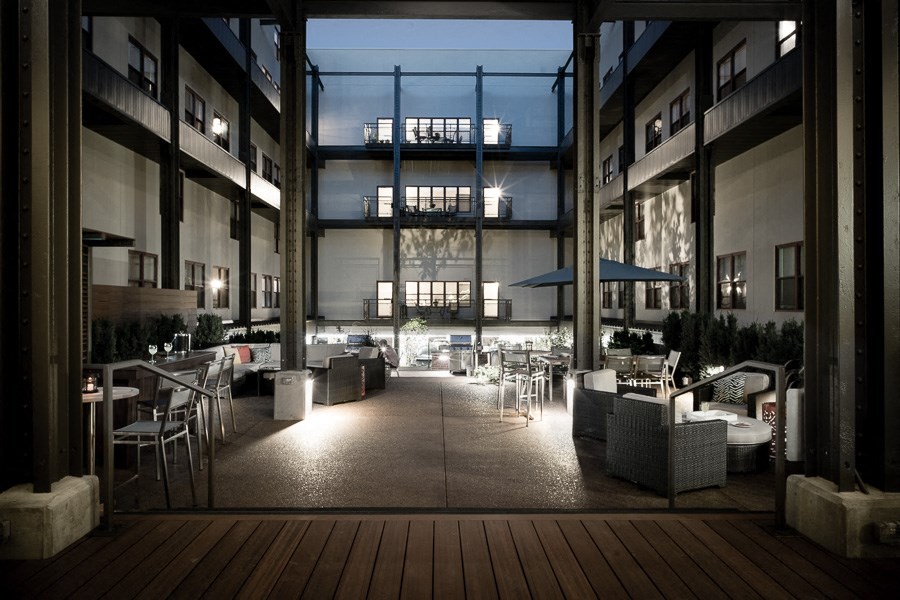 a large lobby with tables and chairs and a large glass window
