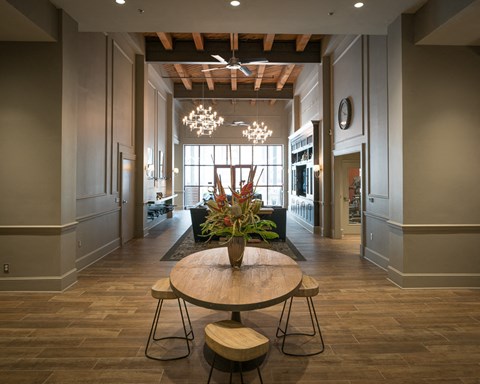 a dining room with a table and a vase of flowers