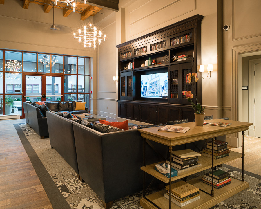 a living room with couches and a table and a television