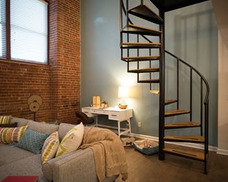 a spiral staircase in a living room with a couch
