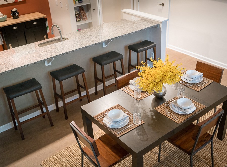 a dining room and kitchen with a table and chairs