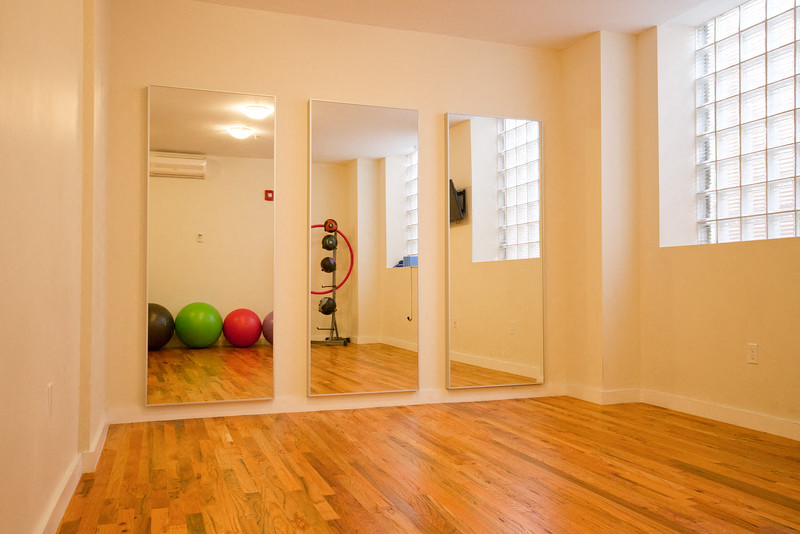 Alternate view of yoga room with mirrors on one wall