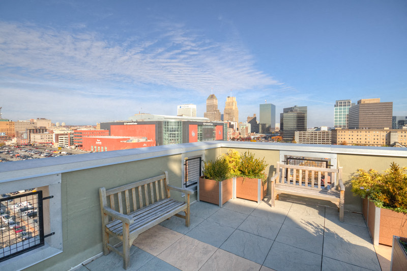 Rooftop seating area with benches and view of Newark NJ