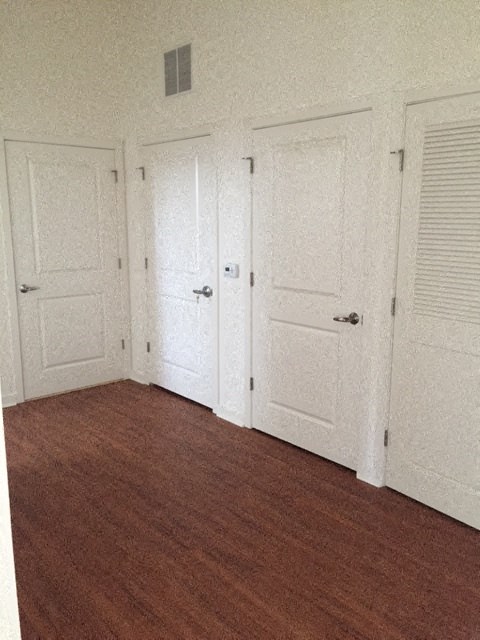 a room with a wood floor and white doors