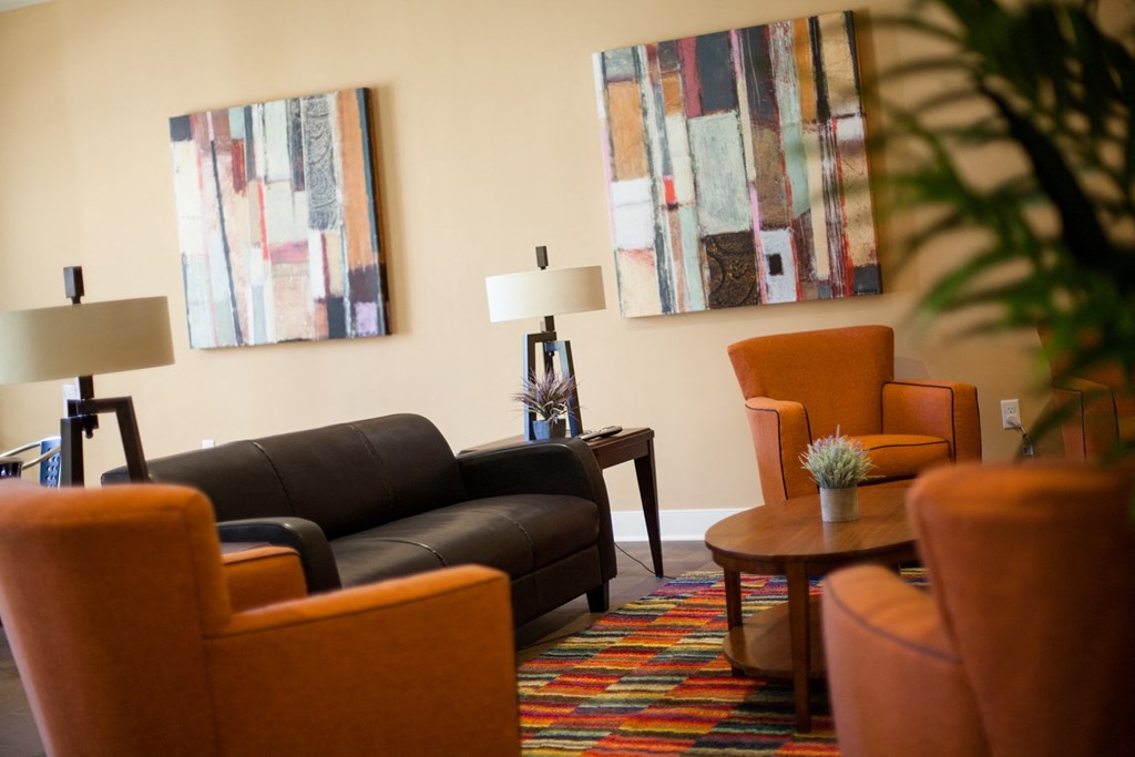 a living room with couches chairs and a table