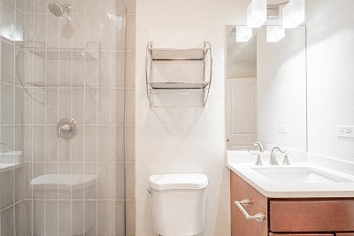 a bathroom with a toilet and a sink and a shower