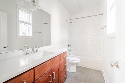 a bathroom with a sink and a toilet and a mirror