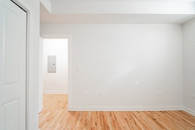 an empty room with white walls and a wooden floor