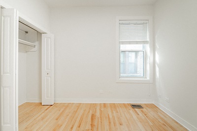 an empty room with white walls and a window
