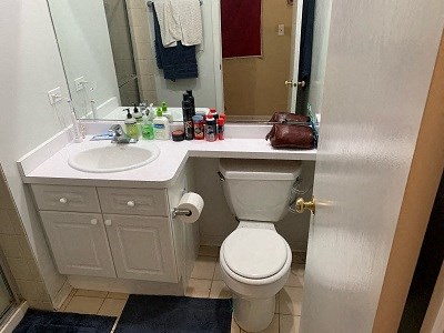 a bathroom with a toilet and a sink and a mirror