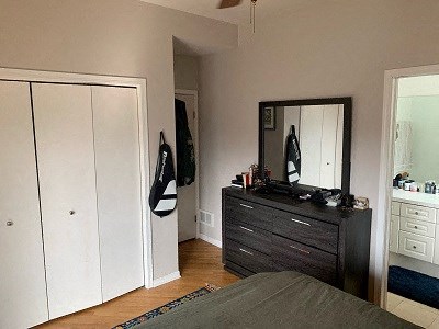 a bedroom with a dresser and a mirror