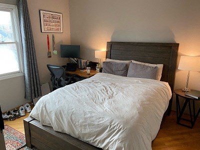 a bed with a white comforter in a bedroom