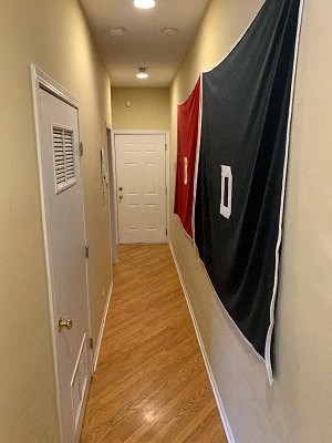 a hallway with a flag on the wall and a door