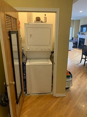 a white washer and dryer in a room with a door