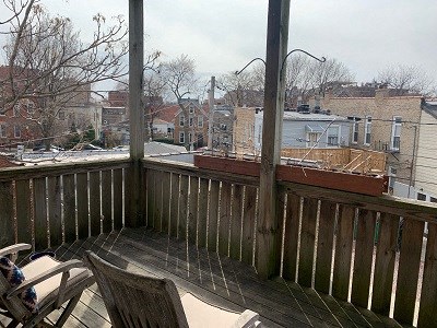 a balcony with chairs and a view of a city