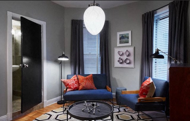 a living room with a blue couch and a table