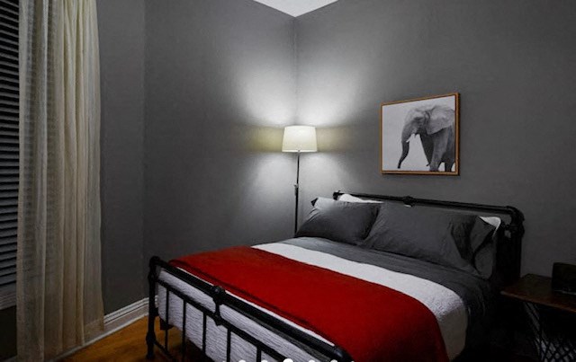 a bedroom with a bed and a picture of an elephant