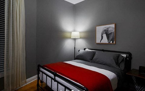 a bedroom with a bed and a picture of an elephant