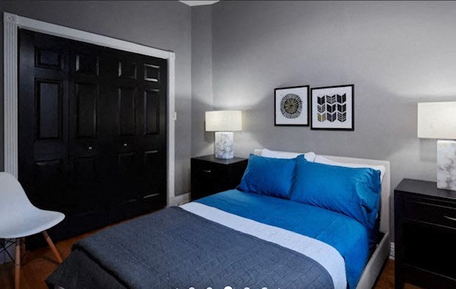 a bedroom with a bed and two black doors