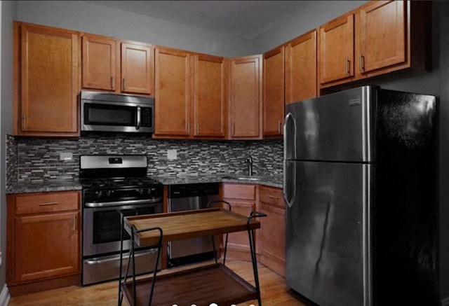 a kitchen with stainless steel appliances and wooden cabinets