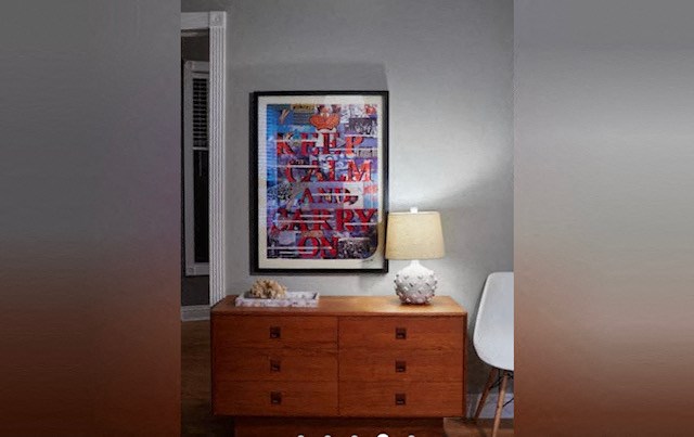 a dresser with a lamp and a picture on the wall