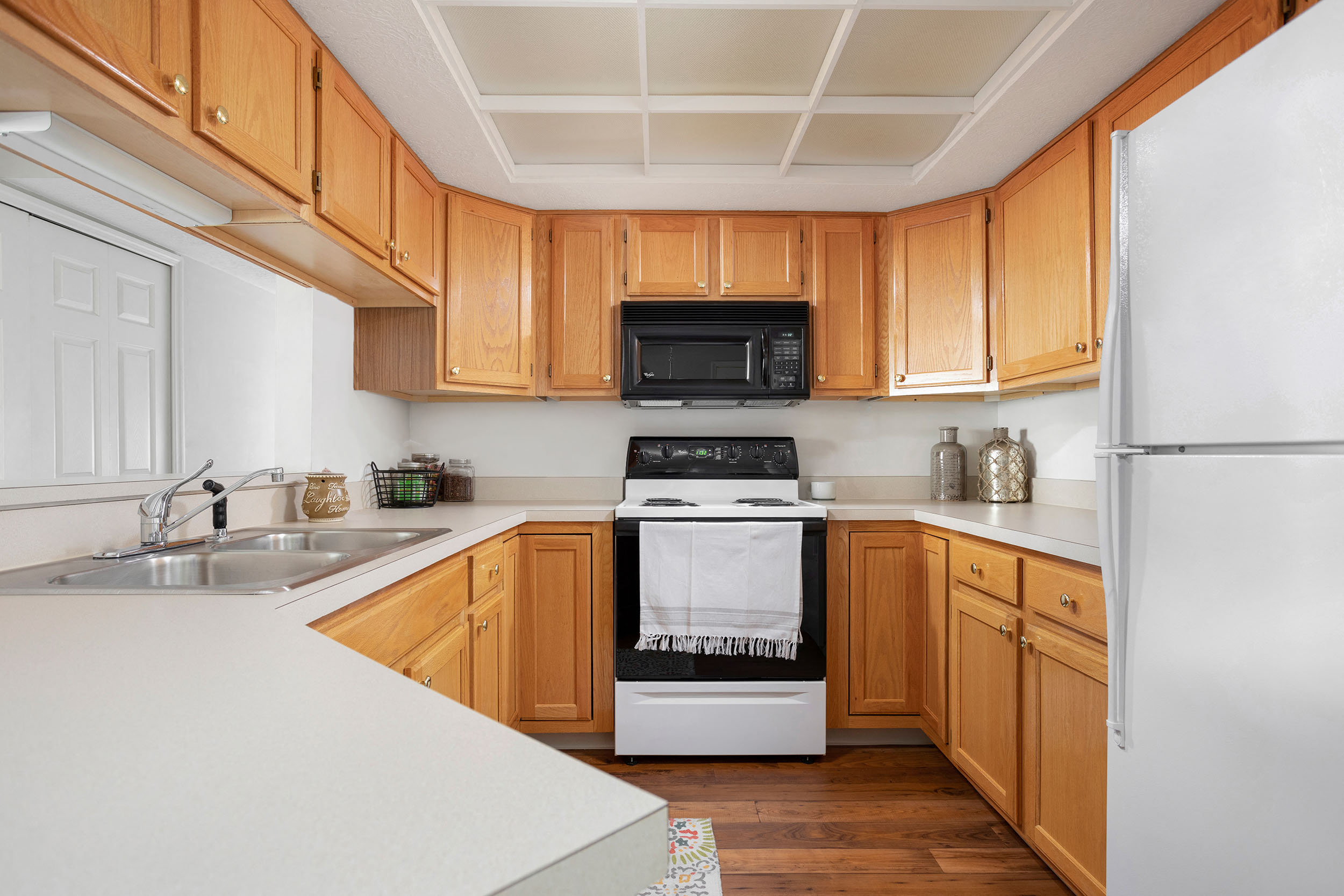 A kitchen with wooden cabinets and a white refrigerator.