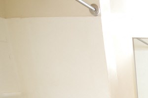 bathroom with light wooden cabinet, white tile floor and white walls - Photo Gallery 2
