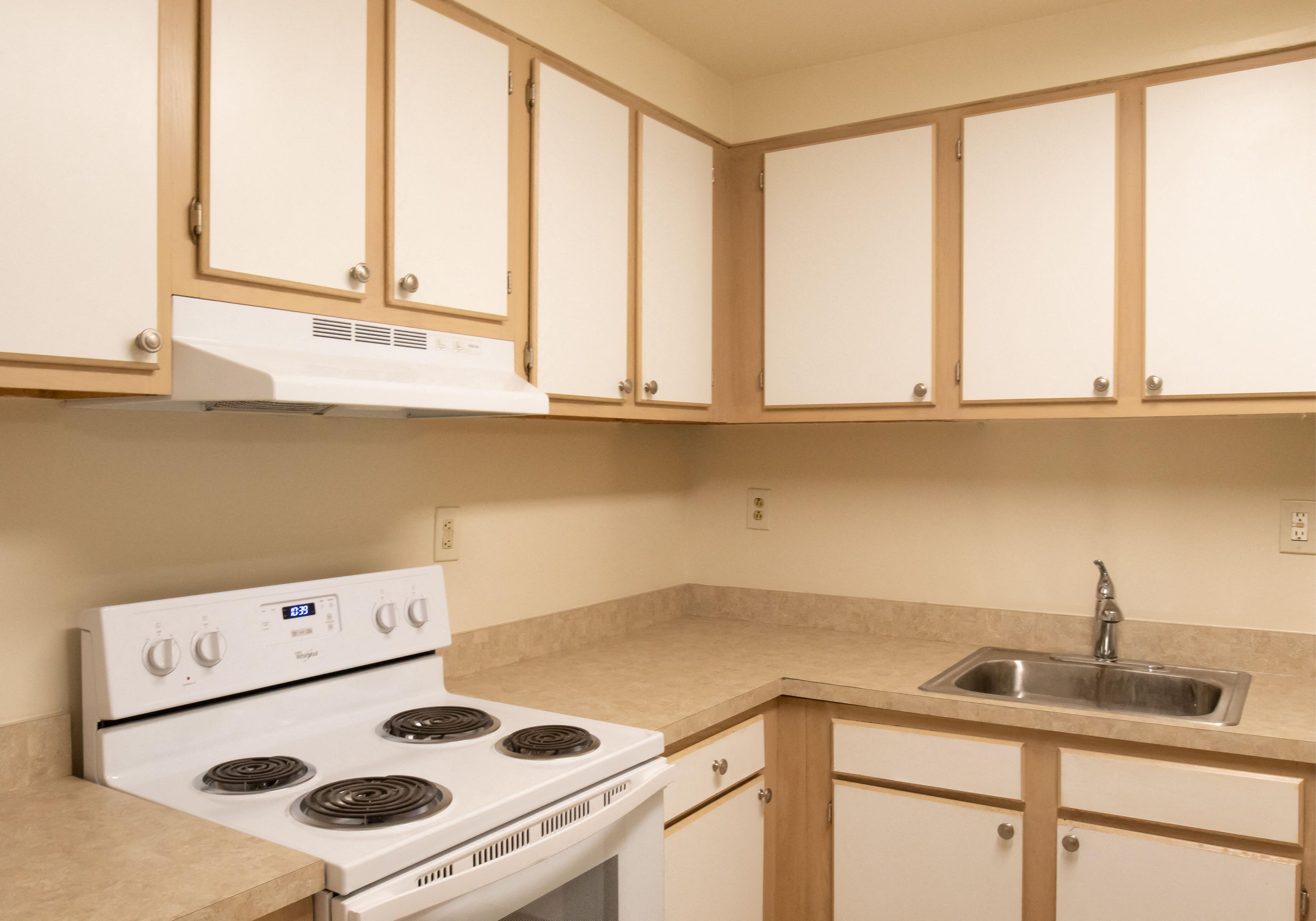 Kitchen with wooden cabinets with white doors