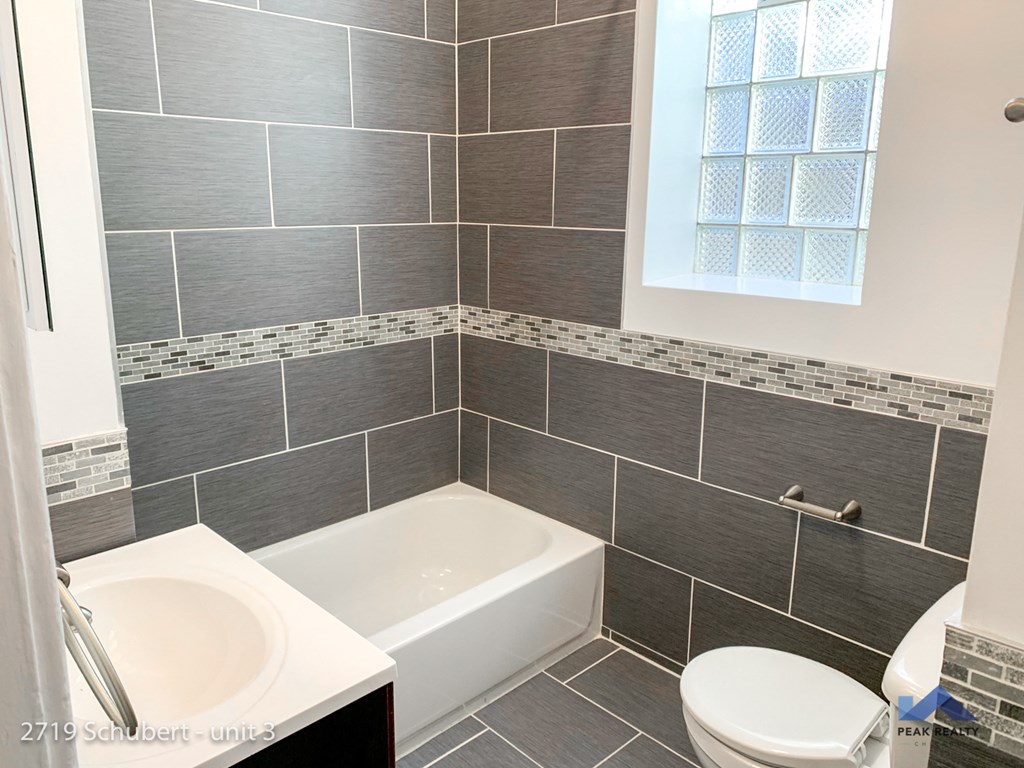 a small bathroom with a tub and a sink and a toilet