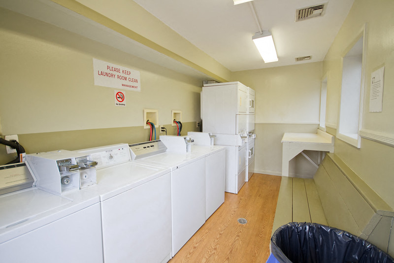 Laundry room with washer and dryer units with folding table