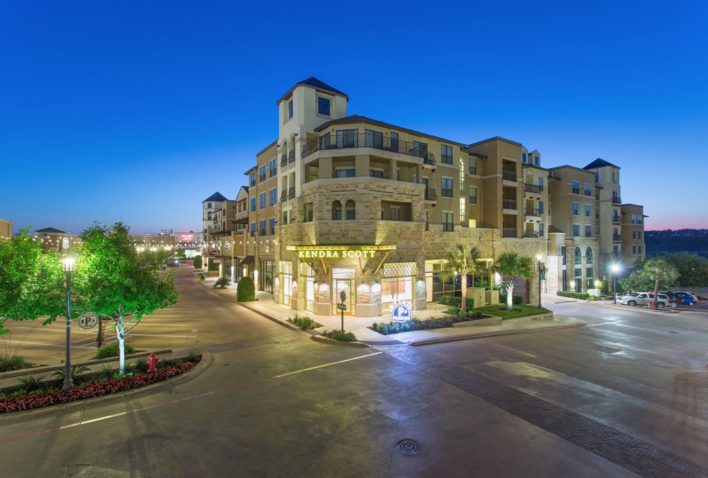 The Quarry Village Shopping Center, a large building on a city street at night