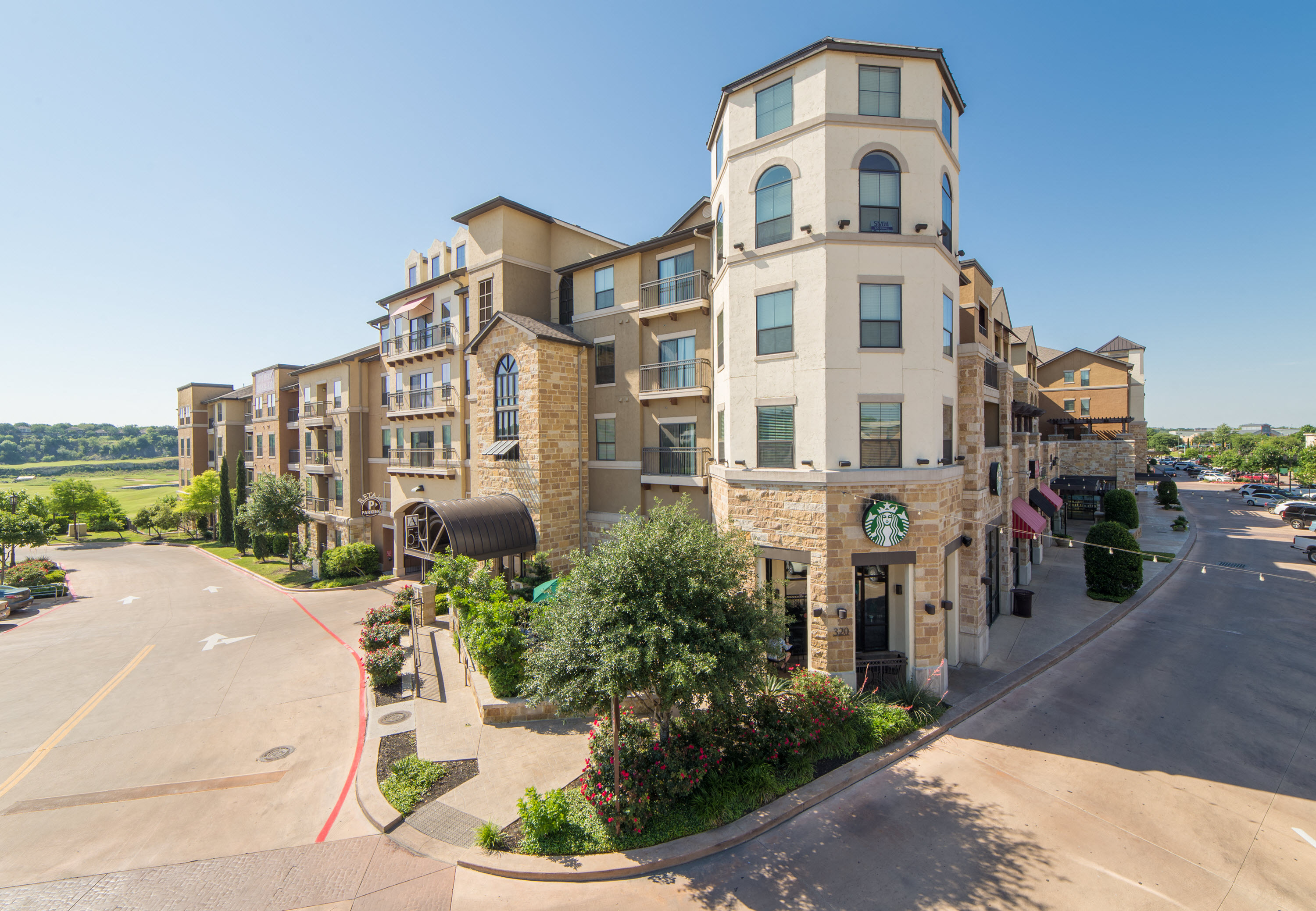 a large apartment building with a street in front of it