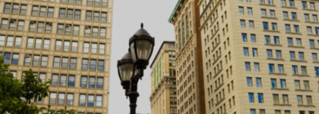 a street light in front of tall buildings