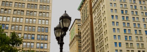 a street light in front of tall buildings