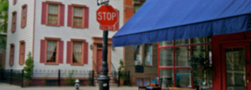 a stop sign on a pole in front of a building