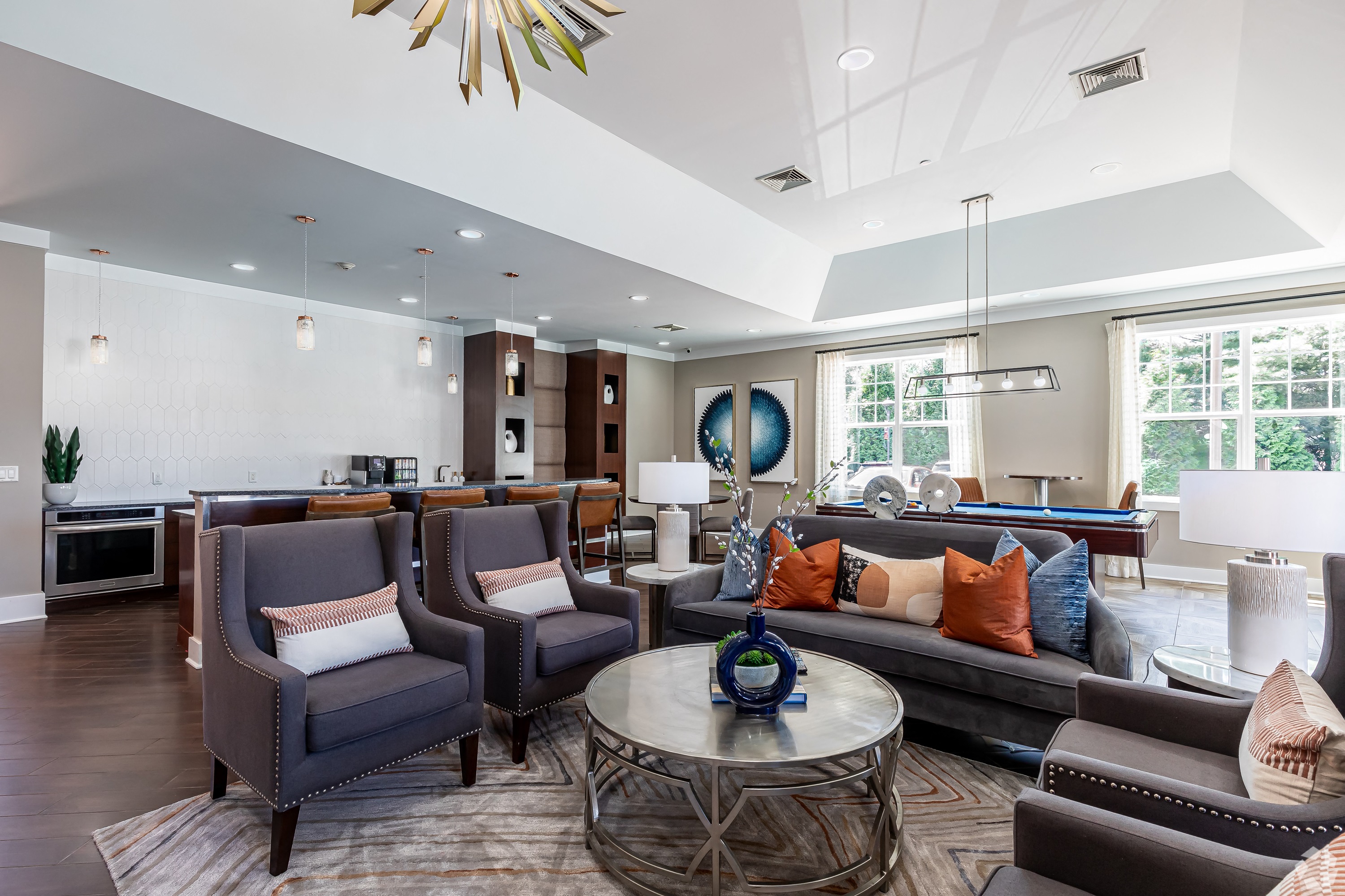 a living room with couches and chairs and a table