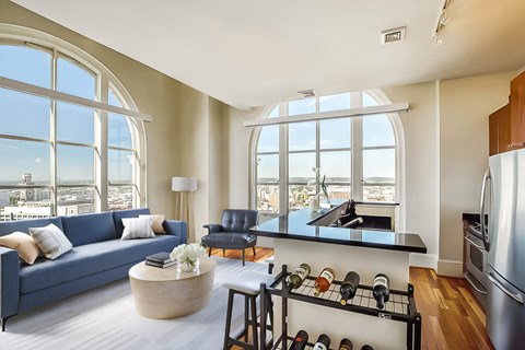 A modern kitchen with a large window overlooking the city.