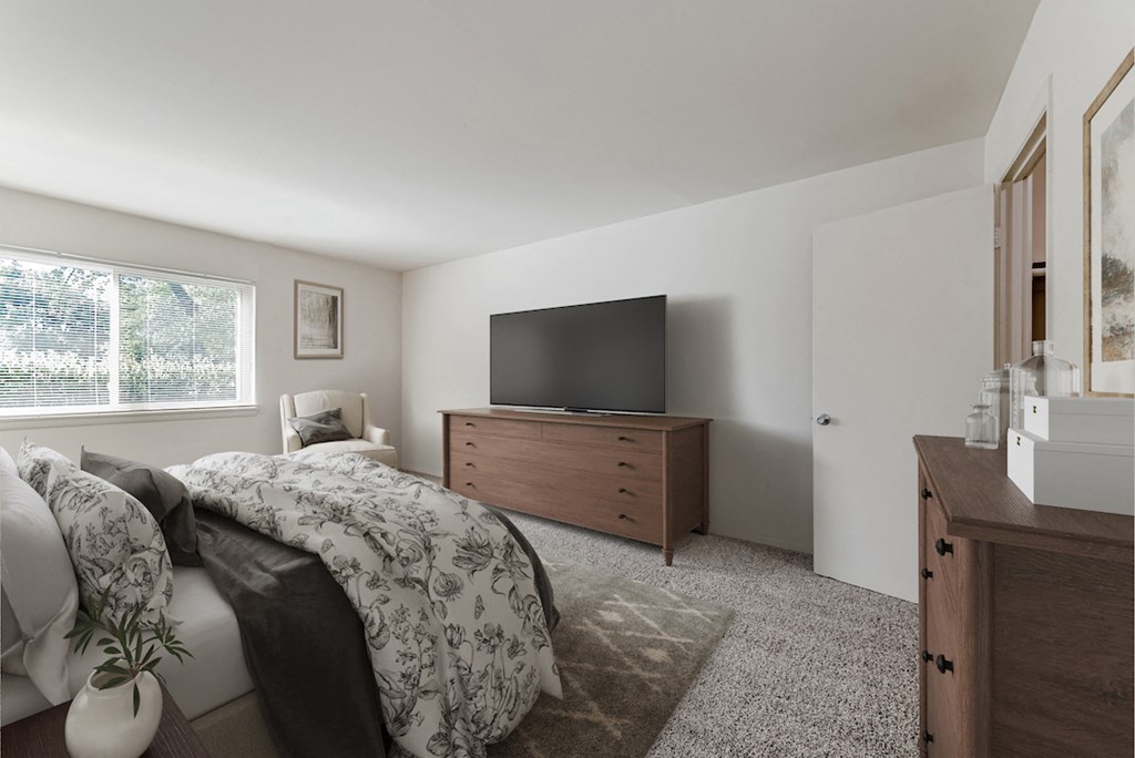 a bedroom with a bed and a tv on a dresser