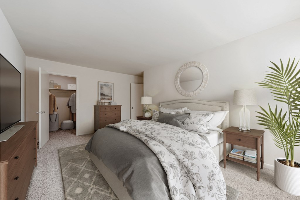 a bedroom with a large bed and a tv