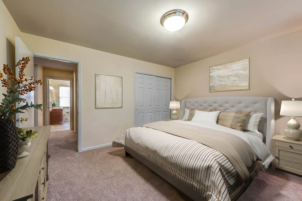 a bedroom with a bed and a door to a bathroom