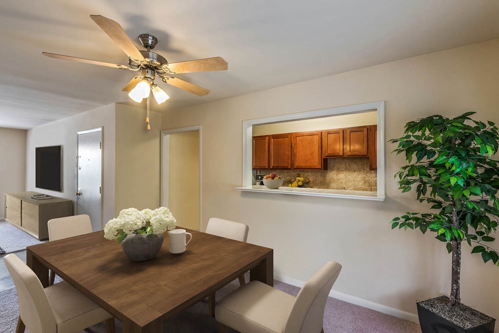 a dining room with a table and chairs and a ceiling fan