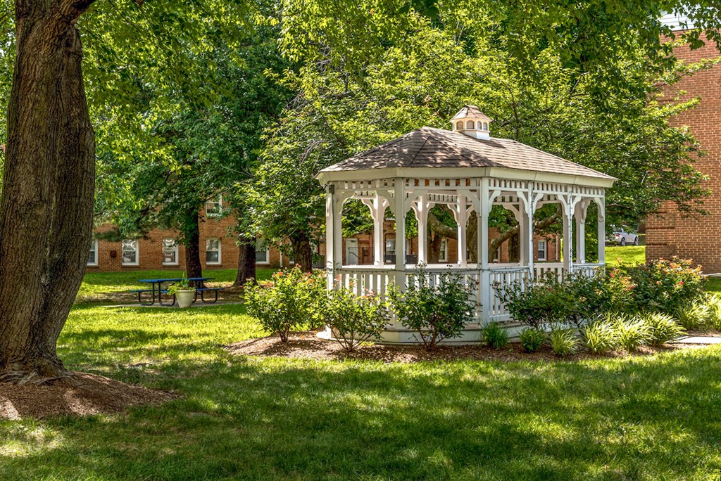a white gazebo in the middle of a yard
