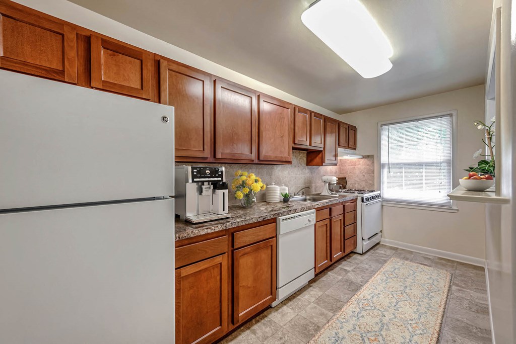 a kitchen with white appliances and wooden cabinets