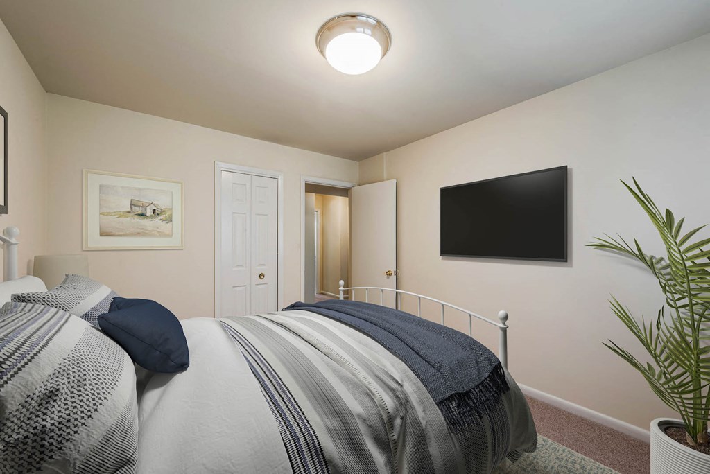 a bedroom with a bed and a television