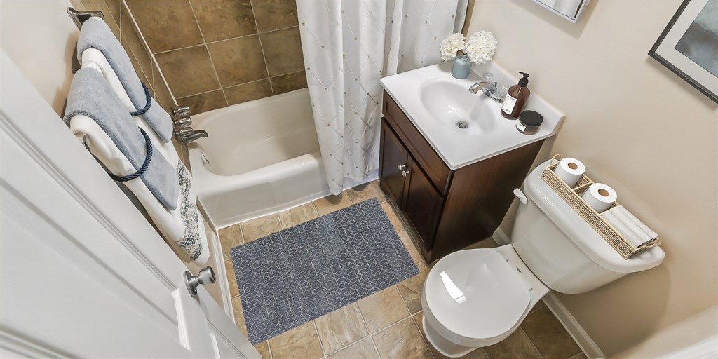 a small bathroom with a toilet sink and shower