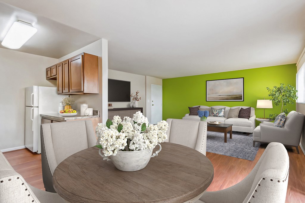 a living room and dining room with a table with flowers